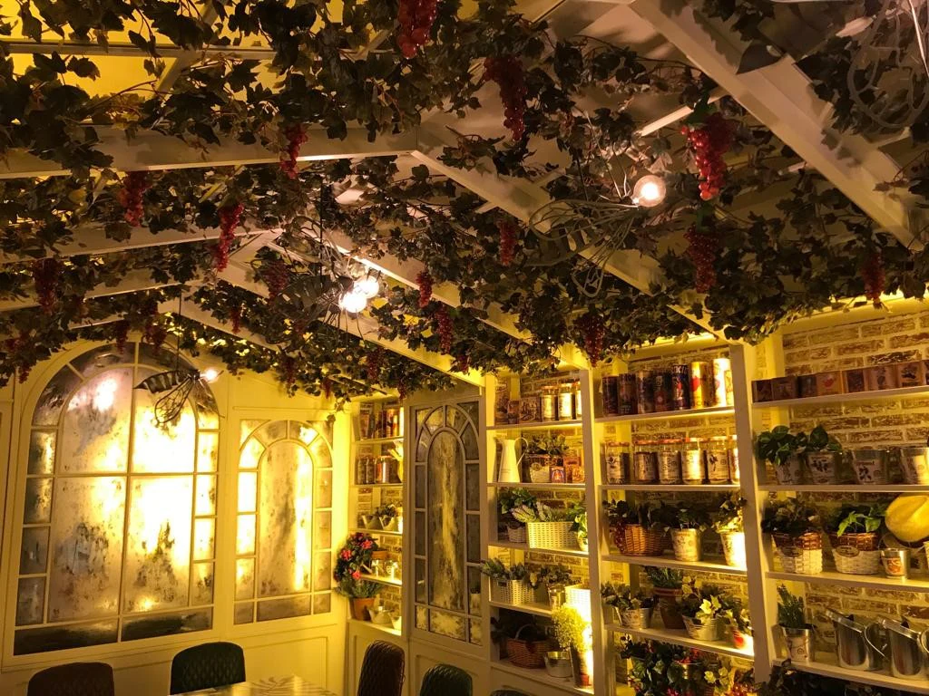 Interior with plants and warm lighting on the shelves and ceiling