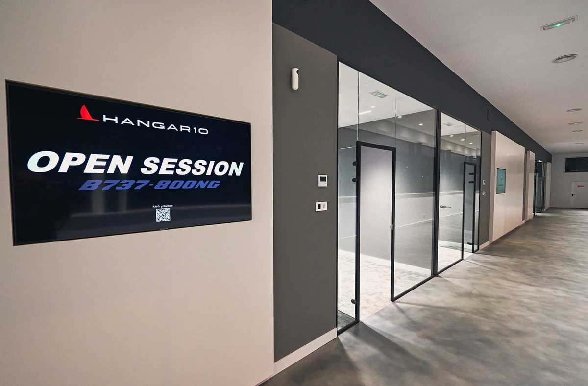 Glazed entrance to rooms with linear ceiling lighting