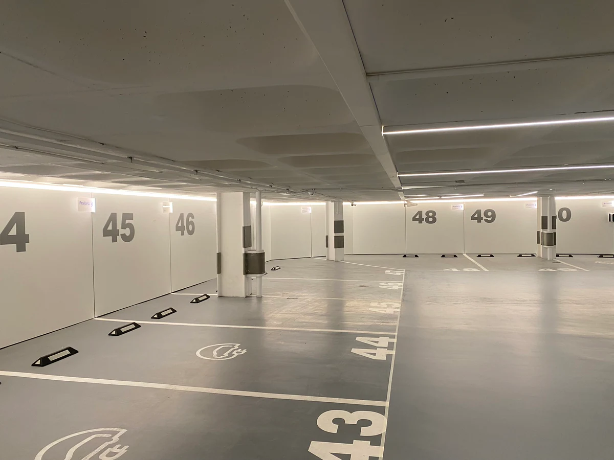Car park with linear lighting and marked parking spaces