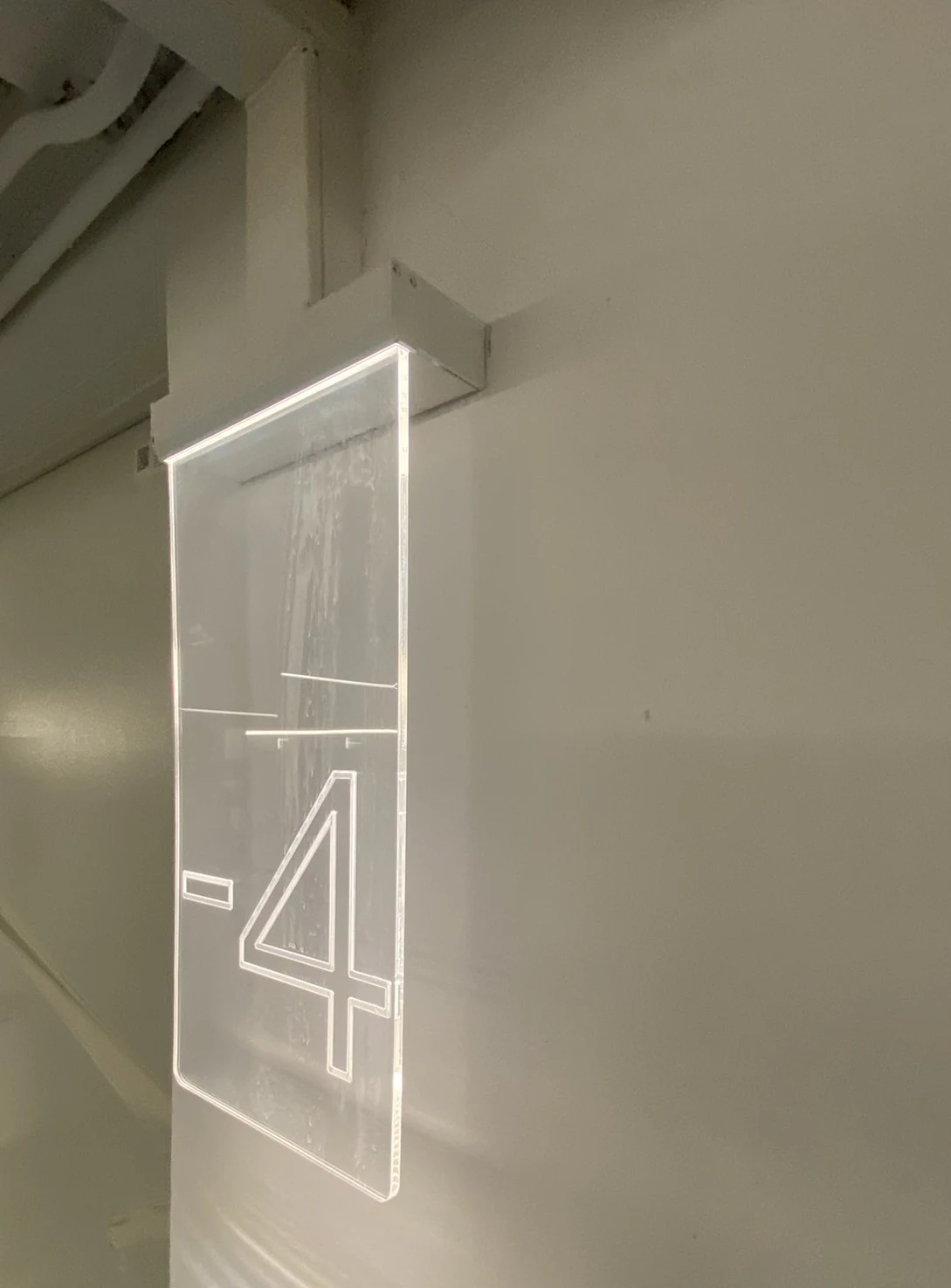 Illuminated level sign integrated into a car park pillar