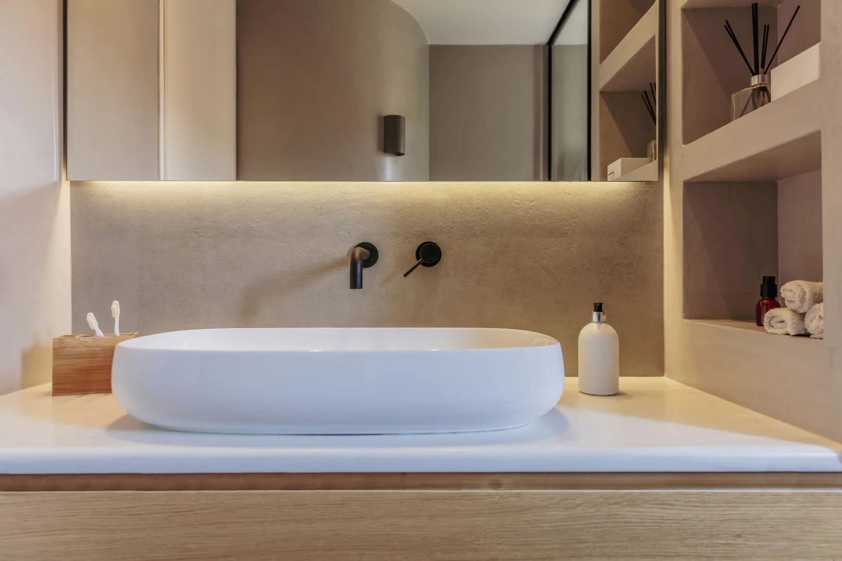 Countertop washbasin with light integrated into the wood cladding
