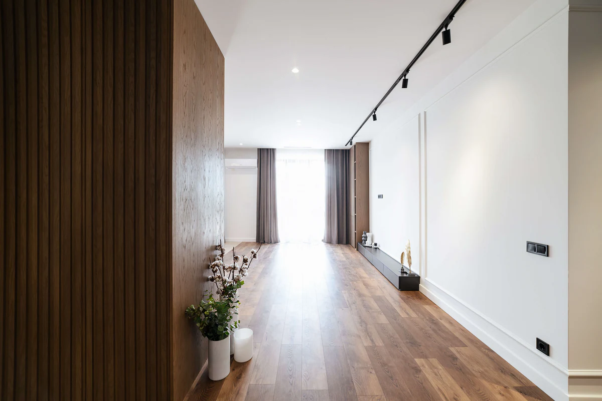 Corridor with a wooden wall and adjustable track spotlights
