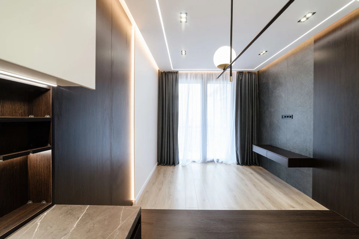 Interior with dark wood panelling and lines of light on the ceiling and wall